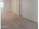 Carpeted living area with doorway and two closets at 42468 W Palmyra Ct, Maricopa, AZ 85138
