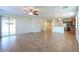 Spacious living area featuring an open layout, tan tile flooring, and abundant natural light at 42468 W Palmyra Ct, Maricopa, AZ 85138