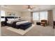Beautifully staged bedroom featuring large windows, a seating area, and carpet at 42468 W Palmyra Ct, Maricopa, AZ 85138