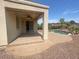 Covered patio overlooking a pool with brick pavers and decorative rock at 42468 W Palmyra Ct, Maricopa, AZ 85138