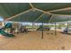 Image of the community playground including a swing set, slide, and climbing structures at 42468 W Palmyra Ct, Maricopa, AZ 85138