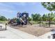 Community playground featuring multiple slides and swings at 42468 W Palmyra Ct, Maricopa, AZ 85138