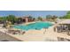 Community pool featuring a large pool, seating, and shade structures at 42468 W Palmyra Ct, Maricopa, AZ 85138