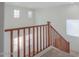 Staircase featuring wood railings and large windows for natural light at 42468 W Palmyra Ct, Maricopa, AZ 85138
