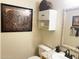 Charming powder room features granite counters, decorative mirror, and animal-themed artwork at 4805 E Kachina Trl # 25, Phoenix, AZ 85044