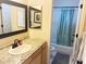 Well-lit bathroom featuring a granite countertop, vanity mirror, and shower-tub combo at 4805 E Kachina Trl # 25, Phoenix, AZ 85044