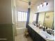 Bright bathroom featuring a dual sink vanity, tub with shower, and modern lighting at 4805 E Kachina Trl # 25, Phoenix, AZ 85044