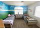 Inviting ' bedroom with twin beds, mountain mural, and natural light at 4805 E Kachina Trl # 25, Phoenix, AZ 85044