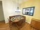 Dining area showcasing a chandelier over a wooden table with 4 chairs at 4805 E Kachina Trl # 25, Phoenix, AZ 85044
