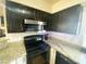 Kitchen with granite countertops, stainless steel appliances, and tile backsplash at 4805 E Kachina Trl # 25, Phoenix, AZ 85044