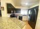 Kitchen featuring granite countertops, dark cabinets, and stainless steel appliances at 4805 E Kachina Trl # 25, Phoenix, AZ 85044