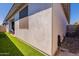 Exterior of home showcasing artificial grass, covered patio and air conditioning unit at 4925 S Turbine --, Mesa, AZ 85212