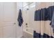 Bright bathroom features shower-tub combo with white subway tile and blue and white striped shower curtain at 4925 S Turbine --, Mesa, AZ 85212