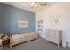 A toddler bedroom with light blue wall, toddler bed, and white dresser at 4925 S Turbine --, Mesa, AZ 85212