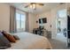 Bedroom with a queen bed, TV, and home office at 4925 S Turbine --, Mesa, AZ 85212