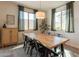 Bright dining area features a stylish wood table, modern lighting, and plenty of natural light at 4925 S Turbine --, Mesa, AZ 85212