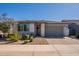 Charming single-story home featuring a well-manicured lawn and a two-car garage at 4925 S Turbine --, Mesa, AZ 85212