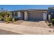 Beautiful single-story home with a gray garage door and a well-maintained front yard at 4925 S Turbine --, Mesa, AZ 85212
