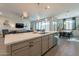 The spacious kitchen island overlooks the dining and living areas, perfect for modern living and entertaining at 4925 S Turbine --, Mesa, AZ 85212