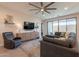 Bright living room with a modern entertainment center and a sliding glass door to the backyard at 4925 S Turbine --, Mesa, AZ 85212