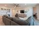 Comfortable living room with a large gray sectional sofa and a modern ceiling fan at 4925 S Turbine --, Mesa, AZ 85212