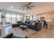 Spacious living room open to the kitchen and dining area, with a large sectional sofa at 4925 S Turbine --, Mesa, AZ 85212