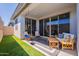 Spacious covered patio features comfortable seating, wooden furniture and artificial turf at 4925 S Turbine --, Mesa, AZ 85212