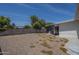 Backyard featuring a gravel base, covered patio, and a mature shade tree at 5657 E Dallas St, Mesa, AZ 85205