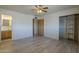 Bedroom with hardwood floors, ceiling fan and access to an ensuite bathroom and closet at 5657 E Dallas St, Mesa, AZ 85205