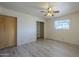 Bright bedroom with neutral walls, closet, and light wood-look floors at 5657 E Dallas St, Mesa, AZ 85205