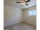 Bright bedroom features a window and sleek flooring providing a simple aesthetic at 5657 E Dallas St, Mesa, AZ 85205