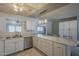 Bright kitchen featuring white cabinets, stainless steel appliances, marble countertops, and seamless access to dining area at 5657 E Dallas St, Mesa, AZ 85205