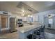 Well-lit kitchen featuring stainless steel appliances, marble countertops, and a breakfast bar with seating at 5657 E Dallas St, Mesa, AZ 85205