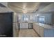 Modern kitchen featuring stainless steel appliances, marble countertops, and seamless access to dining area at 5657 E Dallas St, Mesa, AZ 85205