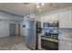 Modern kitchen featuring stainless steel appliances, and seamless access to an adjacent living area at 5657 E Dallas St, Mesa, AZ 85205