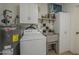Spacious laundry area with washing machine, water heater, and sink at 5657 E Dallas St, Mesa, AZ 85205