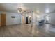 Open-concept living space with hardwood floors, a ceiling fan, and easy access to kitchen at 5657 E Dallas St, Mesa, AZ 85205