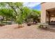 Outdoor backyard with covered patio, gravel, trees and comfortable seating at 5749 S Dragoon Dr, Chandler, AZ 85249