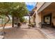 Outdoor backyard with covered patio, gravel, trees and comfortable seating at 5749 S Dragoon Dr, Chandler, AZ 85249