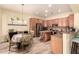 Well-lit kitchen features stainless steel appliances, granite countertops, and a breakfast bar at 5749 S Dragoon Dr, Chandler, AZ 85249