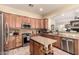 Modern kitchen with granite countertops, stainless steel appliances, and a functional island at 5749 S Dragoon Dr, Chandler, AZ 85249