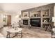 Spacious living room featuring a stone fireplace, built-in shelving, and hardwood flooring at 5749 S Dragoon Dr, Chandler, AZ 85249
