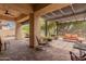 Covered outdoor patio with brick pavers, pergola, ceiling fan and ample seating at 5749 S Dragoon Dr, Chandler, AZ 85249