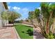 Lush backyard featuring synthetic grass, mature trees, and stone pathway at 6001 N 10Th Way, Phoenix, AZ 85014