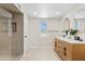 Bright bathroom showcasing a double vanity, modern fixtures, and a glass-enclosed shower at 6001 N 10Th Way, Phoenix, AZ 85014