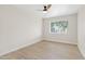 Bedroom featuring wood floors, ceiling fan, and a window view of the backyard at 6001 N 10Th Way, Phoenix, AZ 85014