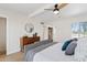 Serene bedroom with a mid-century modern dresser, soft gray accents, and abundant natural light at 6001 N 10Th Way, Phoenix, AZ 85014