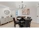 Modern dining room featuring a sleek black table, upholstered chairs, and stylish lighting at 6001 N 10Th Way, Phoenix, AZ 85014