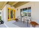 Inviting front porch with stylish seating, flower pots, and a cheerful yellow entrance door at 6001 N 10Th Way, Phoenix, AZ 85014