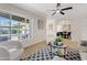 Spacious living room featuring stylish decor, a ceiling fan, and an open archway to the dining area at 6001 N 10Th Way, Phoenix, AZ 85014